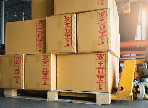 Cargo shipment boxes, Manufacturing and warehousing. Stack of cardboard boxes on pallet at the warehouse storage.